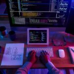top-view-unrecognizable-hacker-performing-cyberattack-night